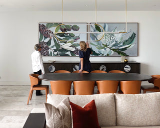 Two individuals in a home setting, with Art to Art offering art consultation as part of our art services. The artwork features a floral design.