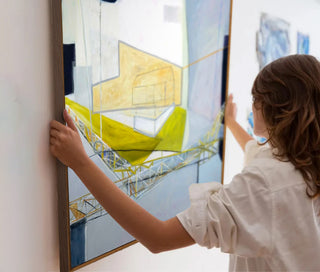 An image of one of our professional team members providing our hanging wall art service.